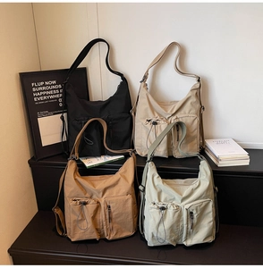 Detail of multi-pocket nylon crossbody bags in four colors with drawstring front pockets