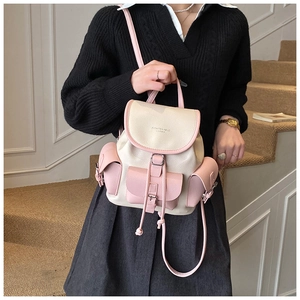 Detail view of lychee texture cream backpack with pink pockets and drawstring closure