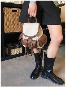 Close-up of vintage mini backpack with ivory and brown pebble grain leather textures