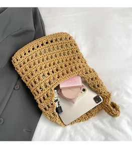 Detail of khaki woven tote bag showing spacious hollow mesh interior for essentials