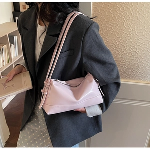 Detail view of pink soft leather shoulder bag worn with a casual blazer outfit