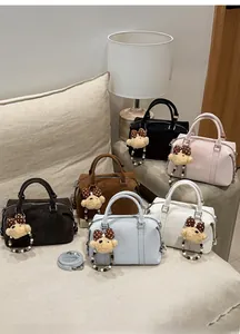 Detailed collection of vintage Boston bags in six colors with teddy bear charms on a sofa
