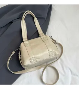 Detail view of cream vintage tote bag showing cross-stitched handles and detachable strap