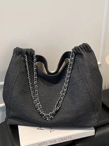 Large denim tote bag with silver chain straps and pleated closure in black finish