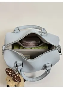 Top view showing the large interior capacity of this light blue Boston bag with accessories