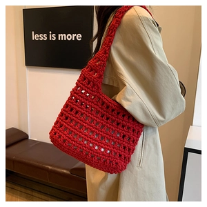 Detail of red handmade woven tote bag showing the intricate hollow mesh structure