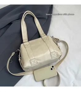Creamy white PU leather tote bag with phone for size comparison and crossbody strap