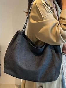 Fashionable denim tote bag with silver chain strap in spacious charcoal grey design