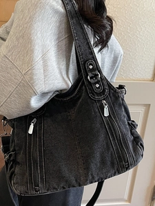 Minimalist black washed denim shoulder bag with silver zippers and rivets for women