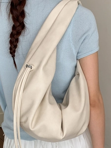 Large cream-white slouchy crescent hobo bag with drawstring detail and matte finish