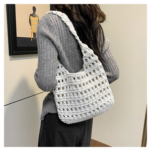 Detail of white crochet tote bag showing woven mesh texture and wavy edge design