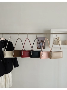 Detailed display of vintage baguette bags in multiple colors with metallic pendants
