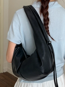 Large black leather crescent hobo bag with wide shoulder strap and drawstring details
