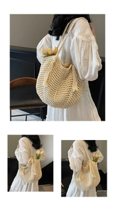 Detail of hollow crochet straw tote bag with long tassels and comfortable shoulder strap