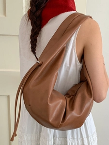 Brown leather pleated hobo bag with drawstring closure for casual shoulder wear