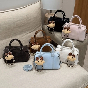 Detail view of colorful Boston bags with bear charms and ZSKERT AIR PARIS brand logo