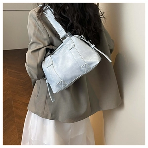 Detail of light blue minimalist tote bag showing stitching and wide shoulder strap