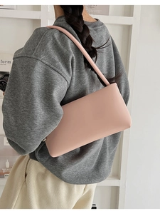 Pink minimalist faux leather baguette shoulder bag shown as a chic underarm purse style