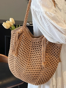 Hollow out woven straw tote bag with tassels and braided strap for beach or daily use