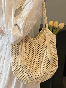 Bohemian beige hollow knit straw tote bag with long tassels for summer beach vacation