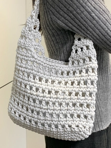 White hand-woven crochet tote bag with thick cotton rope and hollow grid mesh pattern