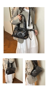 Detail view of black vintage pillow tote bag showing cross stitching and silver hardware
