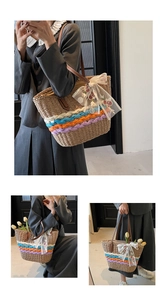 Detail view of handmade straw tote bag with colorful rope accents and floral lace bow