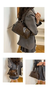 Detail view of vintage dark brown Boston bag with retro matte leather and adjustable strap