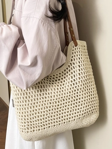 Artistic handmade beige woven tote bag with brown leather straps for beach holidays