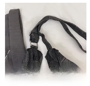 Detail of adjustable houndstooth fabric shoulder strap with silver metal buckles and rings
