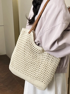 Artistic handmade woven tote bag in cream white with brown leather straps for beach holidays