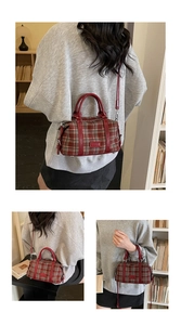 Detail of vintage plaid bowling bag with maroon leather straps and detachable shoulder strap