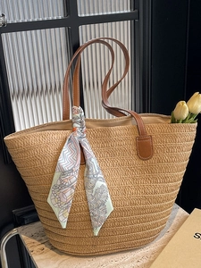 Straw woven beach tote bag with leather handles and decorative floral silk scarf