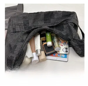 Top view of large capacity tote bag interior showing daily items like a tablet and umbrella
