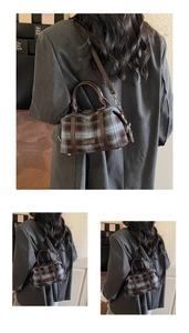 Detail view of vintage plaid Boston bag with leather trim and adjustable shoulder strap