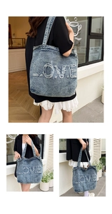 Detail of vintage denim tote bag with frayed LOVE letter embroidery and large capacity