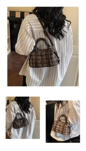 Retro plaid boston bag with brown leather trim and adjustable crossbody strap shown on model
