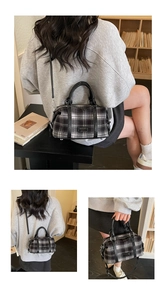 Detail of vintage plaid Boston bag with leather handles and removable shoulder strap