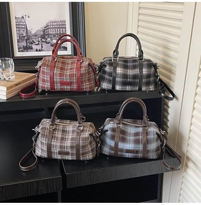 Close-up of retro plaid Boston handbags in red, black, coffee, and blue on shelves