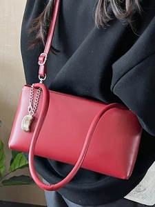 Chic red faux leather baguette shoulder bag with adjustable strap and metal chain detail