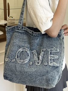 Retro denim tote bag with frayed LOVE letter embroidery and spacious interior for daily use