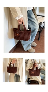 Detail of dark brown hand-woven crochet tote bag with a handmade heart pendant