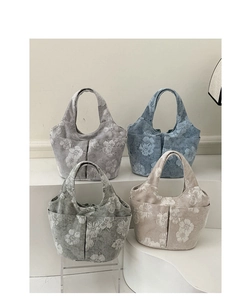 Collection of four embroidered canvas bucket bags with floral patterns and side pockets