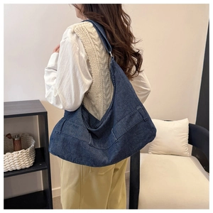 Detail of navy blue large capacity tote bag showing corduroy texture and side pocket