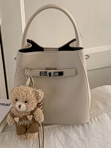 Chic cream white bucket bag in lychee texture leather with a cute bear charm pendant