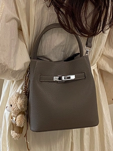 Brown litchi grain leather bucket bag with top handle and cute plush bear charm