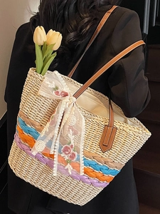 Handmade woven straw tote bag with floral lace ribbon and colorful stripes for beach vacation