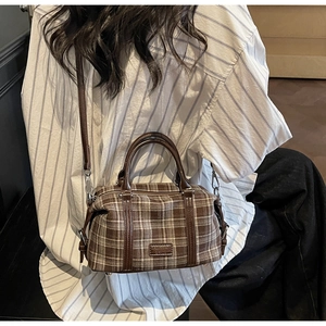 Detailed view of vintage plaid Boston bag showing textures and fashion logo tag
