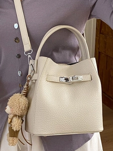 Retro cream litchi texture bucket bag with top handle and brown bear charm on strap