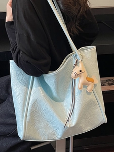 Light blue glossy tote bag with pleated texture and horse charm for commuting women